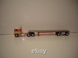Dcp 1/64 Orange And Tan Pete 352 With 86'' Sleeper Cab And Spread Axle Flatbed